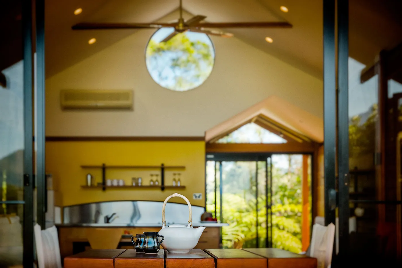 The Bower interior — warm timber walls, comfortable furnishings, soft afternoon light